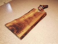 Photo of natural wood charcuterie board made from Acacia, showing wood grain and board shape