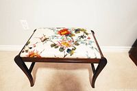 Top view showing floral fabric upholstery of the vintage stool.