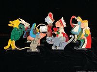 Full view of nine assembled figures on black background