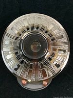 Front view of smoked glass compote bowl showing etched geometric design and circular form