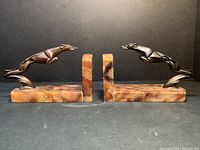 Pair of Art Deco greyhound metal and marble bookends, side view.