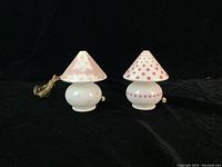Two frosted white glass mushroom-shaped Bellova lamps side by side showing overall size and shape.