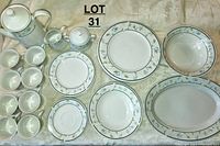 Full view of the complete set including cups, plates, bowls, serving pieces and coffee/tea pot.
