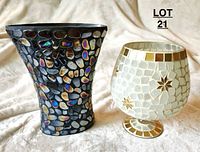 Two mosaic vases placed side by side on light fabric background, showing overall shape and tile detail.