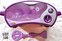 Top view of the purple Easy Bake Oven with floral design, control knob, timer, and an included purple spatula