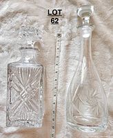 Photo showing both glass decanters side by side with ruler for scale, highlighting differing shapes and stopper styles