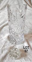 Full view of the tall glass/crystal vase with cut pinwheel design and separate round flower holder