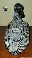 Front-facing view of the soapstone goose figurine showing intricate carving of feathers and textured body surface.