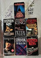 Display of seven Stephen King books: The Dark Tower: The Gunslinger, Waste Lands, Black House, Needful Things, The Green Mile, The Dead Zone, and Christine.