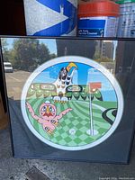 Framed circular limited edition print titled "A Birdie" by Richard Hunt showing stylized birds on a golf green.