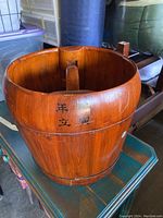 Front and side view of the wooden bucket showing exterior and Chinese characters
