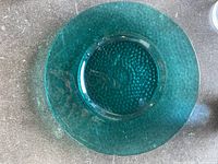 Large textured smoke blue glass bowl or shallow vase seen from top showing textured and translucent blue glass.
