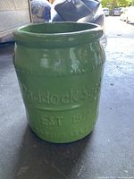 Front view of large green ceramic flower pot showing 'Paddock seed' and 'EST 1932' embossing.