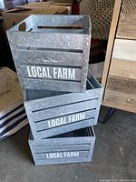 Three galvanized metal square storage bins stacked inside each other with 'LOCAL FARM' text.