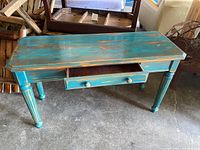 Front view of turquoise shabby chic tall table with one drawer pulled out showing distressed paint and vintage design details.