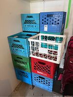 Stacked milk crates in assorted colors showing overall lot contents.