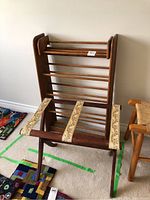 Photo of wooden CD rack, upright with horizontal slats.