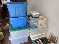 Showcases all containers stacked together displaying size variety and colors: blue, clear, white, and cream.