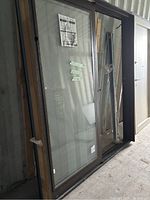 Front view of sliding glass door with dark brown aluminum-clad wood frame and built-in blinds