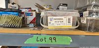 Wide view of shelf showing boxes and containers of various nails and screws, with labels visible including U2 Fasteners 9 x 2 3/4 screws
