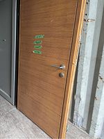 Full view of the door slab leaning against container walls