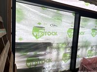 Sliding glass patio door installed in rough opening with protective house wrap visible behind