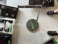 Toilet paper holder viewed from above showing circular base and horizontal arm