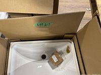 Photo of the TOTO bathroom sink inside the box showing the sink and box interior.