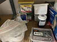 Photo showing multiple boxes and containers of various screws including particle board screws and drywall laminating screws