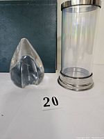 Teardrop clear glass paperweight and rainbow glass pillar candle holder together