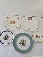 Five vintage collectible plates featuring young Queen Elizabeth, King George, a Coronation theme, and Silver Jubilee commemorations.