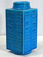 Full view of vase showing square-section body and turquoise glaze