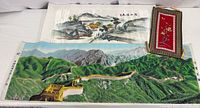 Long woven thread Great Wall of China wall hanging and smaller textile pieces displayed on white background