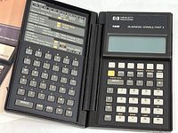 View of the opened HP-19B calculator showing numeric keypad and LCD screen on right, with QWERTY keyboard and function keys on left panel.