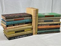 Two stacks of vintage hardcover Random House plays from the 1950s-60s, showing varying spine colors and fonts, some with dust jackets intact.