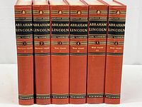 Photo of six vintage hardcover books in red and black with gold embossed lettering showing their spines vertically, titled Abraham Lincoln by Carl Sandburg.