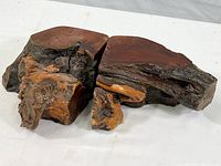 Pair of matching burl root wood bookends shown side by side, highlighting the rugged natural textures and polished surfaces.