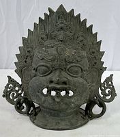 Front view of the Mahakala mask showing detailed facial features and ornamental elements.