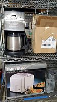 Wide view showing Cuisinart coffee machine, cardboard box, and boxed Faberware pasta maker on metal wire shelf.