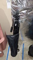 Sony tripod folded standing next to Sony branded black carrying case