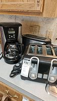 Mr. Coffee coffee maker, four-slice toaster and Hamilton Beach two-slice toaster on countertop