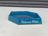 Blue hexagonal ceramic Belmont Milds cigar ashtray with white branding and multiple cigar rests.