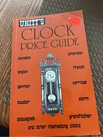 Photo of the orange cover of 'Unitt's Clock Price Guide', detailing types of clocks included in the guide.