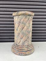 Photo of a 20-inch tall pottery garden plant stand with a marbled stone-like appearance and textured finish