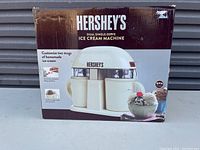 Box of Hershey's dual single-serve ice cream machine showing product image, description, and branding.