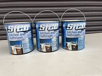 Three unopened cans of Sico Kitchen and Bathroom paint with labels visible showing product details.
