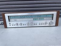 Front panel view showing tuning dial, control knobs, meters, and Technics branding