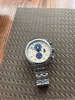 Front view of watch face and bracelet on textured mat