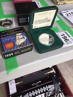 Original green velvet case with Canadian silver proof coin and certificate inside showing detailed coin and packaging.