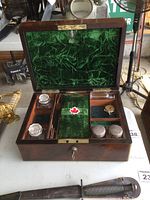 Open writing box showing overall layout, green velvet lining, brass hardware and included items
